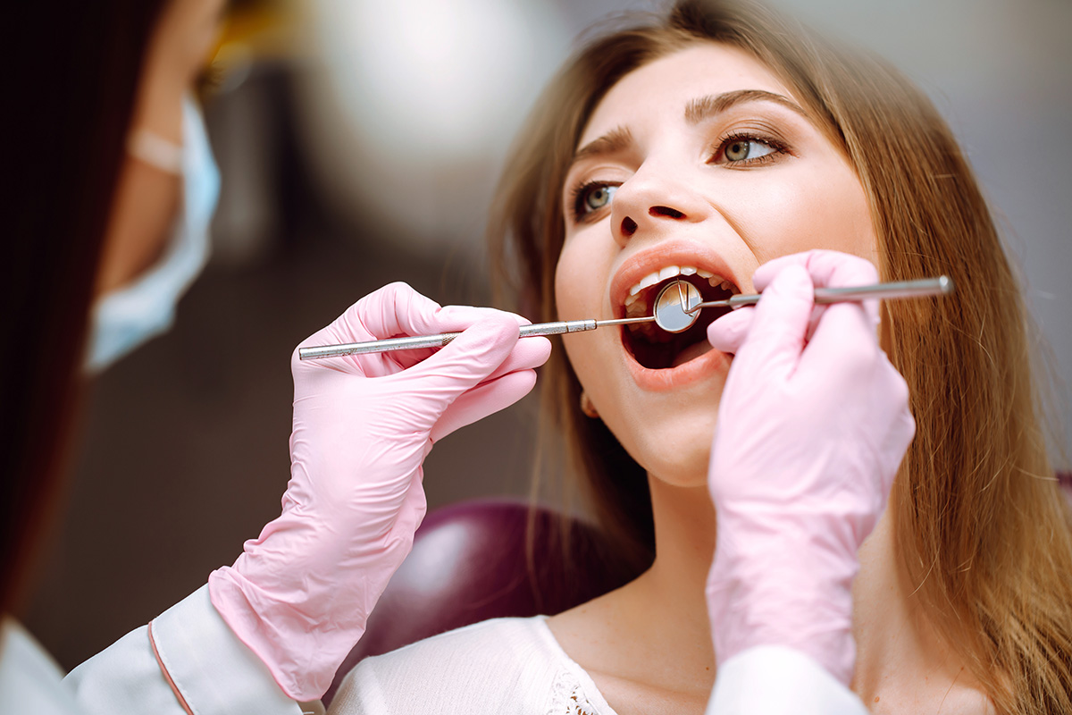 Young woman at the dentist's chair during a dental procedure.